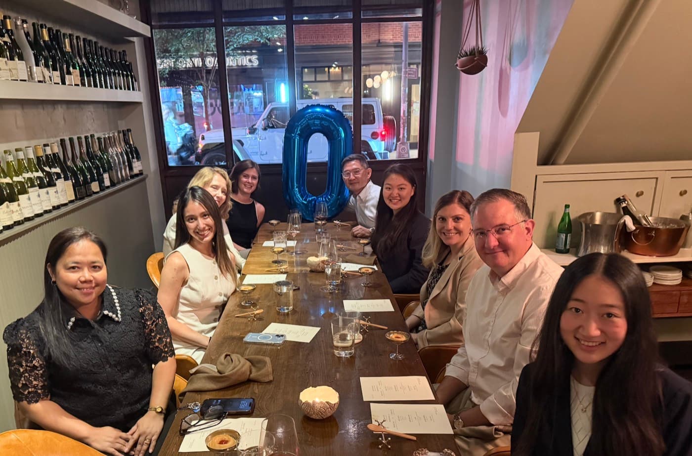 Oxus dinner in New York City, guests beside a letter O balloon